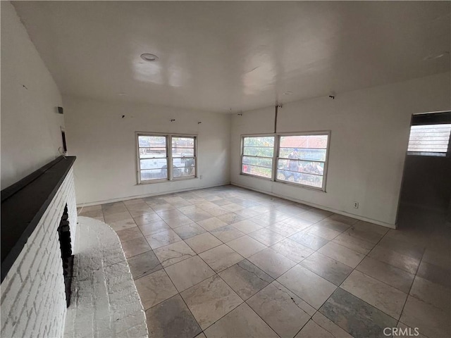 unfurnished living room featuring baseboards