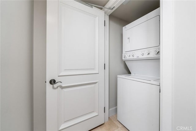 washroom featuring laundry area and stacked washer / dryer