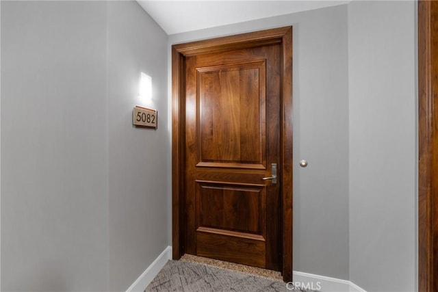 entryway with light carpet and baseboards