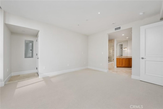 unfurnished room featuring light carpet, electric panel, visible vents, and baseboards