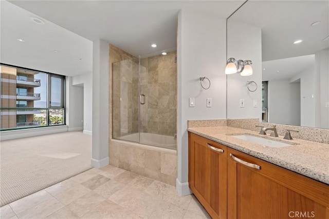 full bathroom featuring tiled shower / bath, recessed lighting, vanity, and baseboards