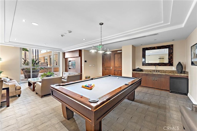 recreation room featuring a raised ceiling, billiards, and recessed lighting