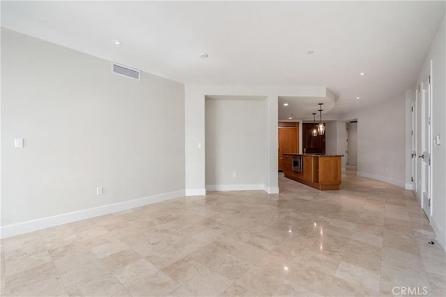 unfurnished living room featuring recessed lighting, visible vents, and baseboards