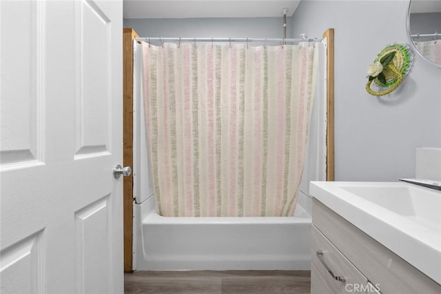 full bathroom featuring shower / bath combo, wood finished floors, and vanity