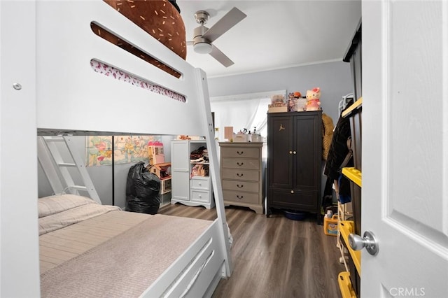 bedroom with ceiling fan, crown molding, and wood finished floors