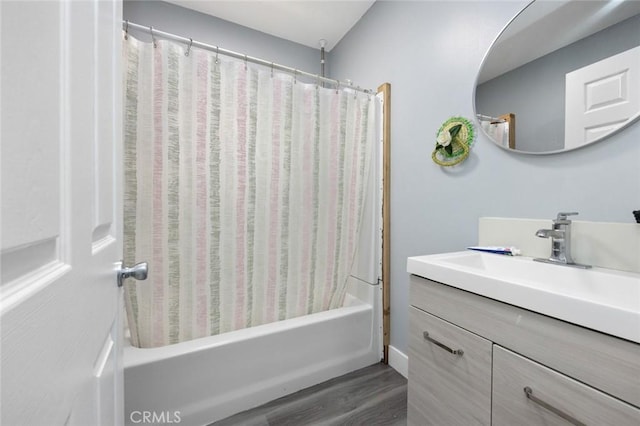 full bath with shower / tub combo, vanity, and wood finished floors