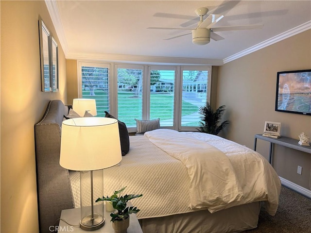 bedroom with a ceiling fan, carpet, and crown molding