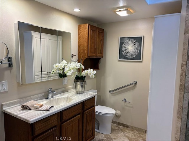 bathroom with toilet, recessed lighting, baseboards, and vanity