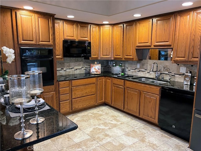 kitchen with black appliances, decorative backsplash, brown cabinetry, and a sink