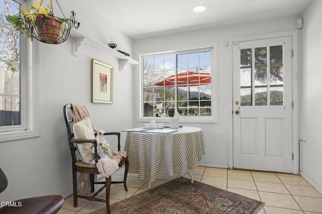 doorway featuring recessed lighting, baseboards, and tile patterned flooring