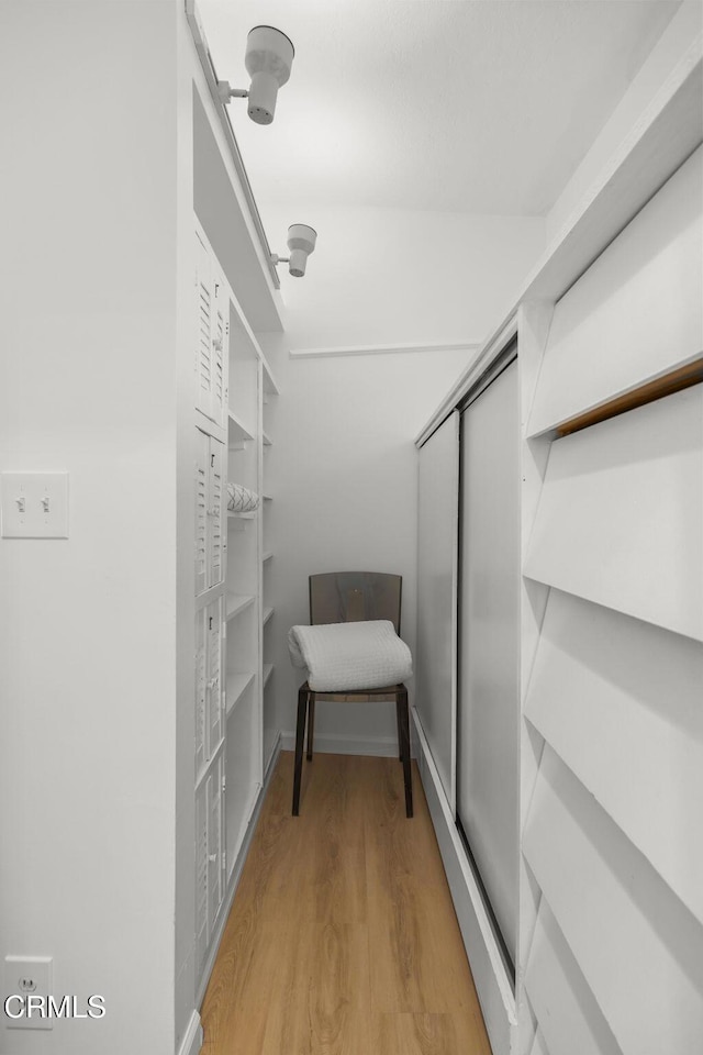 spacious closet with wood finished floors