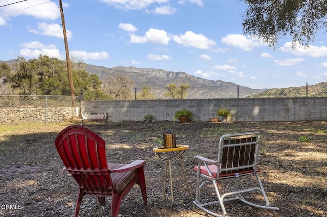 view of yard with a mountain view and a fenced backyard