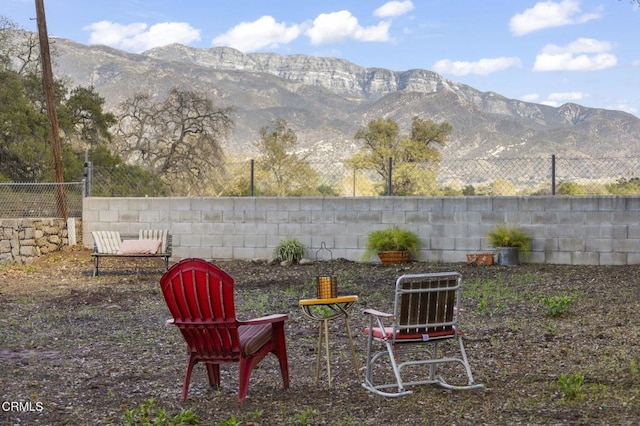 view of yard with fence and a mountain view