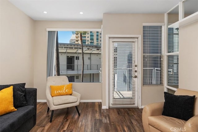 living area featuring recessed lighting, wood finished floors, and baseboards