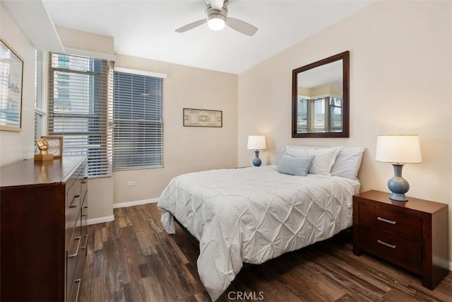 bedroom with dark wood-style floors and baseboards