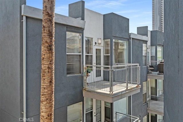 exterior space featuring a balcony and stucco siding