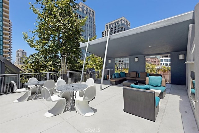 view of patio / terrace with outdoor lounge area, a city view, and outdoor dining space