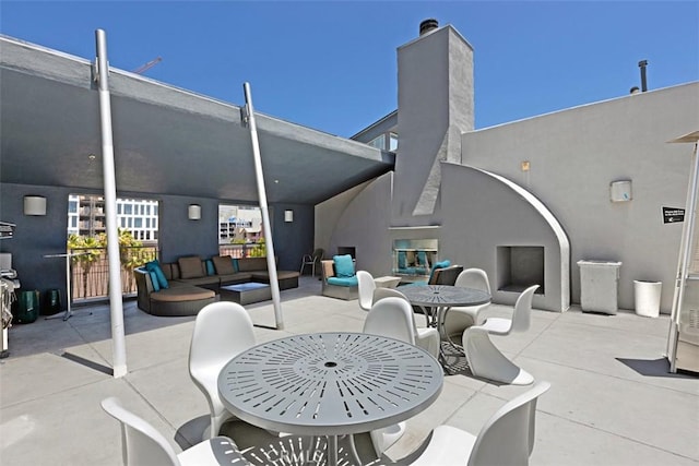 view of patio / terrace featuring outdoor dining space and an outdoor hangout area