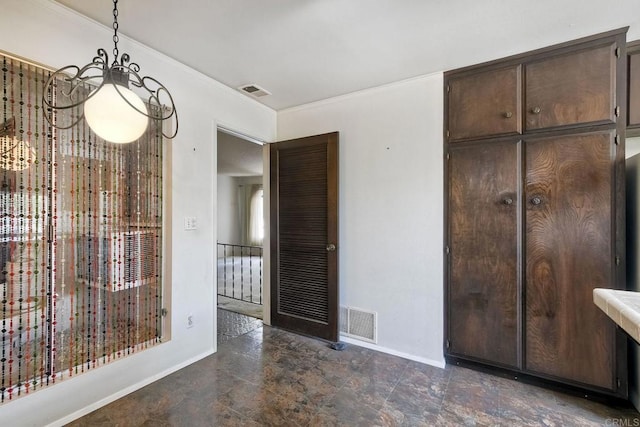 interior space with stone finish flooring, visible vents, crown molding, and baseboards