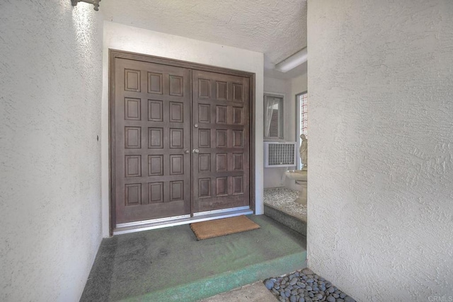 entrance to property with stucco siding