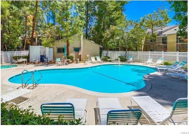 pool featuring a patio and fence