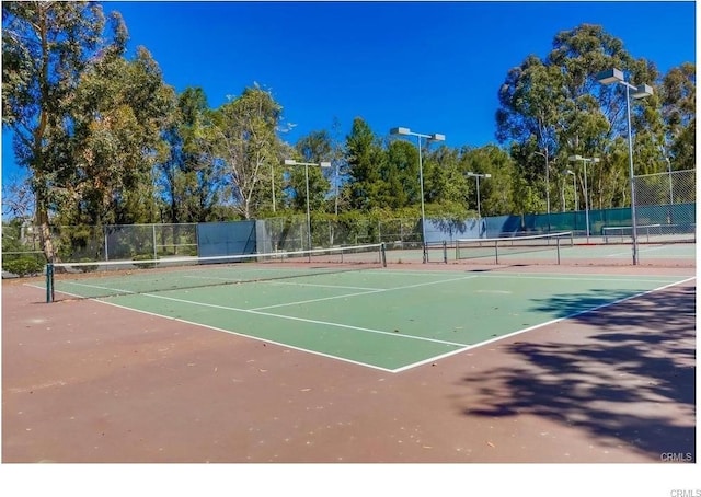 view of tennis court with fence