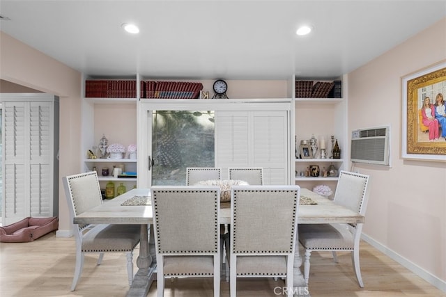 dining space with recessed lighting, baseboards, wood finished floors, and a wall mounted AC