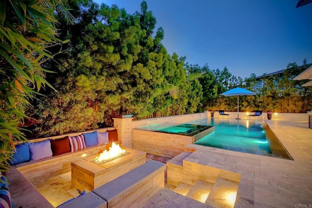 pool with an in ground hot tub, a fire pit, and a patio