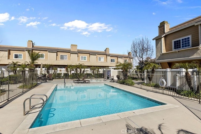 pool with fence and a patio