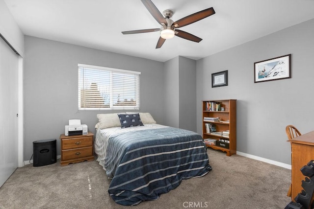 carpeted bedroom featuring ceiling fan, a closet, and baseboards