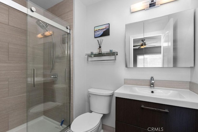 full bathroom with a shower stall, toilet, and vanity