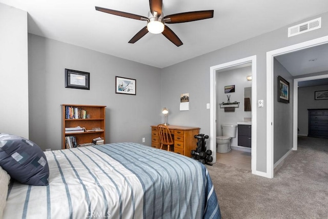 carpeted bedroom featuring baseboards, visible vents, ceiling fan, and connected bathroom