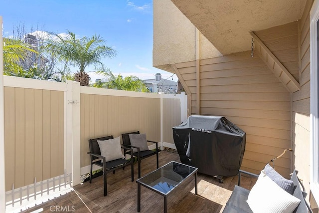 view of patio / terrace with a grill and fence