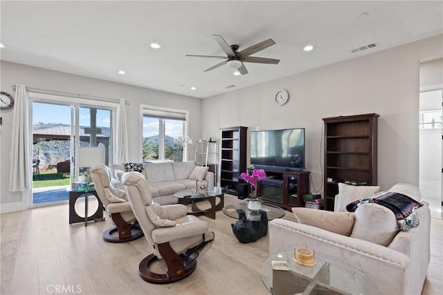 living area with recessed lighting, visible vents, ceiling fan, wood finished floors, and baseboards