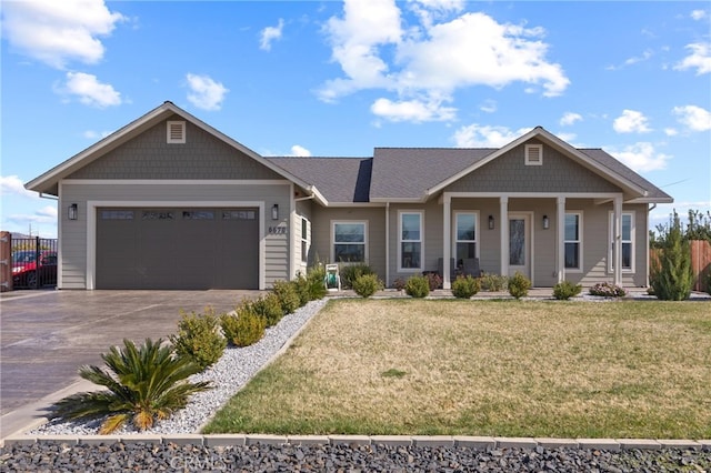 craftsman house featuring an attached garage, fence, a front lawn, and concrete driveway