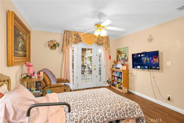 bedroom featuring wood finished floors, visible vents, baseboards, access to exterior, and crown molding