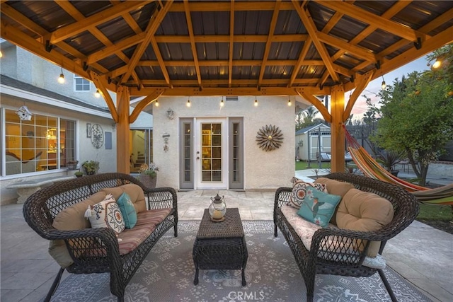 view of patio / terrace with outdoor lounge area, an outdoor structure, a gazebo, and a storage unit