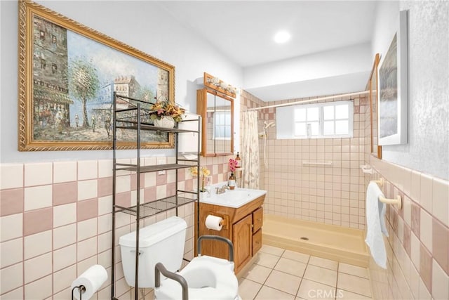 bathroom featuring toilet, tile walls, and a shower stall