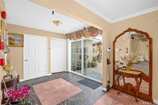 doorway to outside featuring baseboards and crown molding