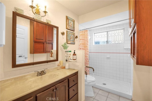 full bathroom with tiled shower, vanity, toilet, and tile patterned floors