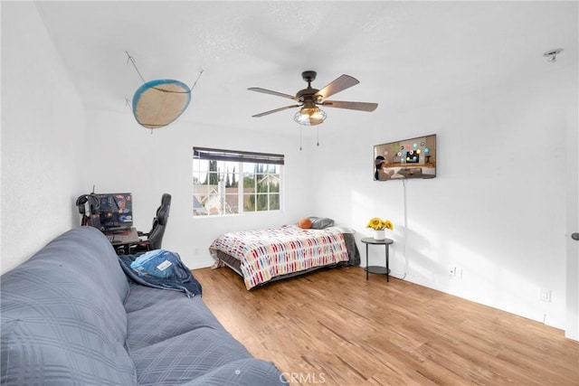 bedroom featuring wood finished floors and a ceiling fan