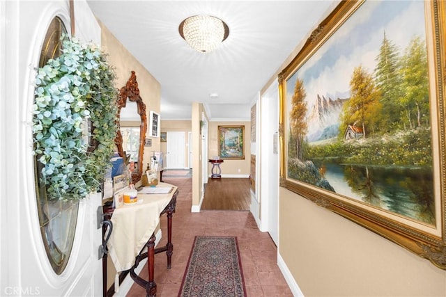 hallway with tile patterned flooring and baseboards