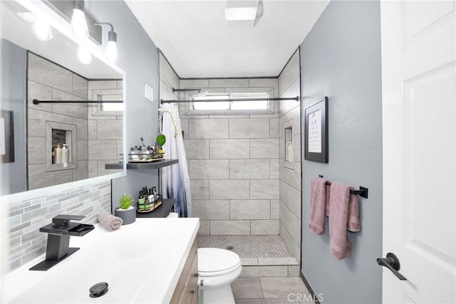 full bath with vanity, a shower stall, toilet, and decorative backsplash