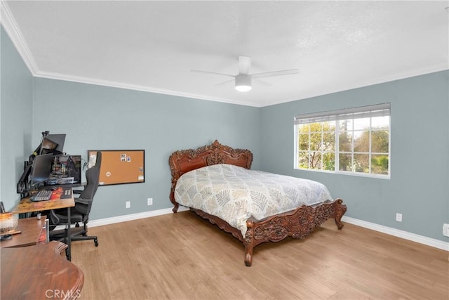 bedroom with baseboards, ceiling fan, ornamental molding, and light wood-style floors