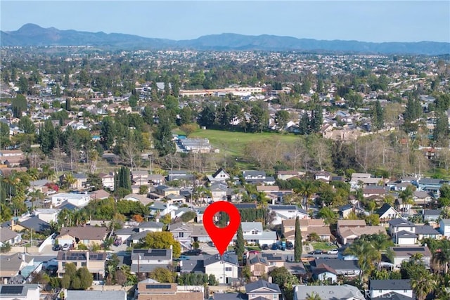 drone / aerial view featuring a residential view and a mountain view