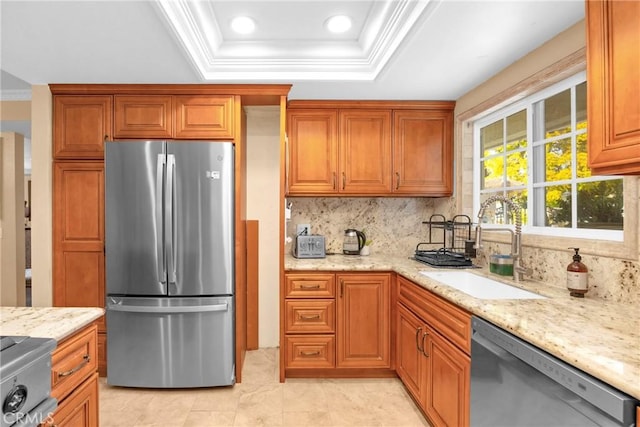 kitchen with stainless steel appliances, crown molding, and a sink