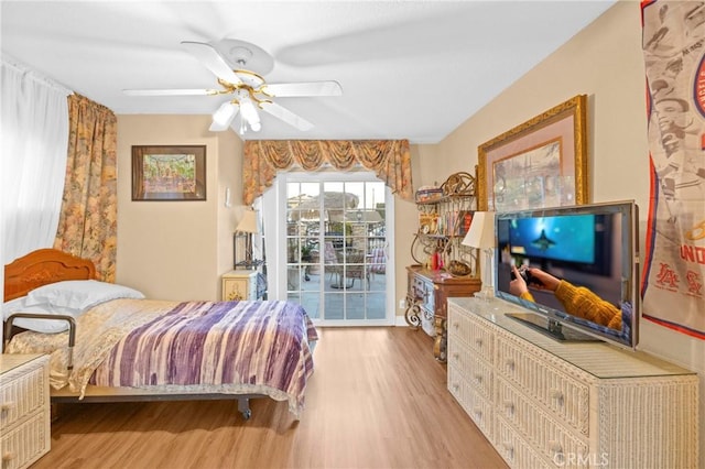 bedroom with access to exterior, ceiling fan, and wood finished floors