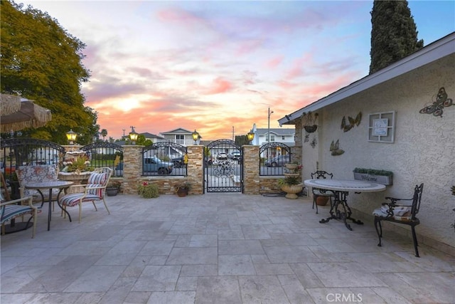 view of patio with fence and a gate