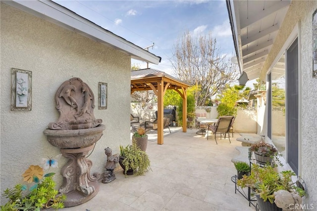 view of patio / terrace featuring fence and a gazebo