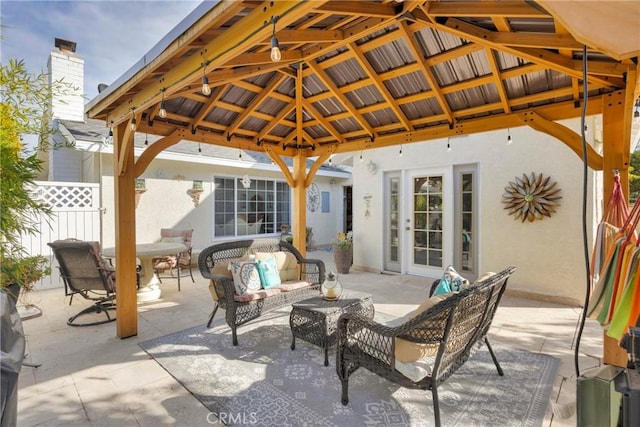 view of patio with fence, a gazebo, and an outdoor hangout area